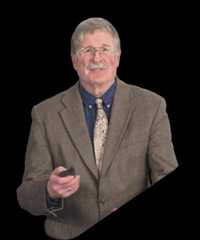 Older man with gray hair, glasses, and plaid blazer smiling.