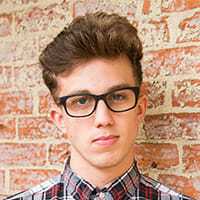 Testimonial john d John d, a young man with glasses and a plaid shirt.