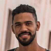 Smiling young man with beard and short dark hair, testimonial.