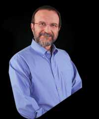 Vincent Racaniello, a man with glasses and a beard, smiling.