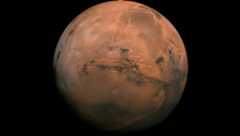 Mars appears rusty red against the black background of space.