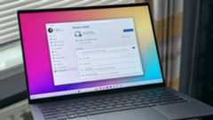 ASUS Zenbook 14 OLED laptop displaying Windows 11 with Windows Update screen