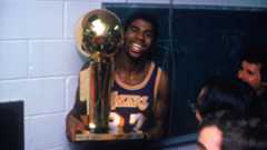 Magic Johnson holding the Walter A. Brown championship trophy