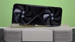 An RTX 5090 sitting on top of its retail packaging against a green background