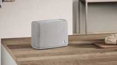 An Audio Pro A15 W speaker on top of a wooden kitchen countertop or island