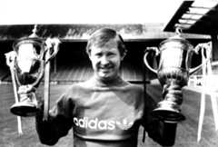 Aberdeen manager Alex Ferguson poses with the Scottish Premier Division and Scottish Cup trophies in August 1984.