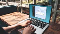 A person using a laptop with Norton VPN activated.