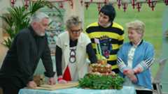 The judges of The Great British Baking Show examine a cake