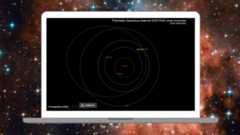  A laptop is pictured showing the orbital path of an asteroid around Earth.