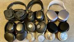 A selection of headphones on a fabric tablecloth 