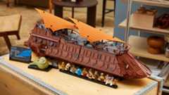 A completed Lego Star Wars Jabba's Sail Barge set out on a table top complete with its minifigures.