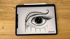 iPad Pro M2 on a desk with a drawing of an eye on the screen