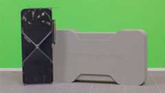 An Nvidia GeForce RTX 5080 on a desk with its retail packaging