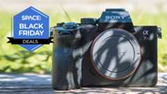 A Sony A7R IV camera on a wooden surface.