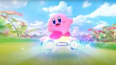 A screenshot from the Kirby Air Riders reveal trailer, showing Kirby waving to the camera.