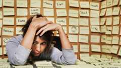 Woman sits amongst post it notes