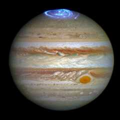 This image of auroras on Jupiter is a composite of ultraviolet observations by the Hubble Space Telescope taken in 2016 and a visible light image of the planet taken in 2014.