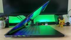 Side view of Razer Blade 16 gaming laptop sitting in a wooden gaming setup