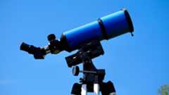 iOptron 80mm white light solar telescope on a tripod against a blue sky