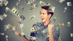 Happy man making money using his laptop