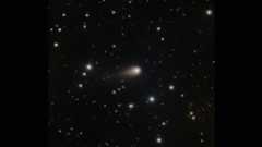 A streak of white shows interstellar comet 3I/ATLAS in the center of a starry night sky