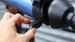 A close-up of the focusing knob on the telescope tube