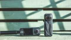 The Insta360 X5 and X4 Air cameras side-by-side in natural sunlight