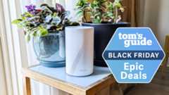 The TP-Link Deco BE67 mesh router on a table with a Tom's Guide Black Friday deals badge