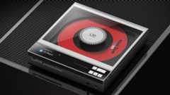 Shanling ECZero AKM on a ribbed dark grey surface with a red CD visible inside the device