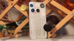 The Nothing Phone (3) leaning on a wine rack.