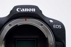 A Canon Inc. EOS R100 mirrorless digital camera on display at the CP+ Camera and Photo Imaging Show in Yokohama, Japan,