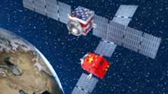Two satellites with solar panels on either side, one with a USA flag and one with a Chinese flag, hover above Earth in this illustration