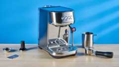 the breville bambino plus / sage bambino plus in stainless steel silver photographed against a blue background shown with its accessories including milk jug, tamper, portafilter, and shown in use extracting espresso