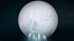 An illustration of a gray planet spewing blue water at the south pole