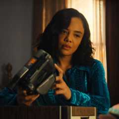 tessa thompson as anna looking at an old cam corder and its footage in a still from netflix's his and hers