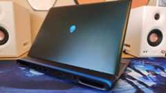 An Alienware 16 Area-51 laptop on a wooden desk