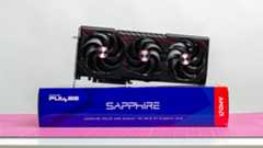 An AMD Radeon RX 9070 XT made by Sapphire on a table with its retail packaging