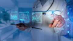 A person in a white coat presses icons in the space in front of them to represent mixed reality