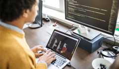 A man coding on a laptop on one of the best online coding courses