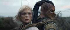 Elle Fanning as Thia and Dimitrius Schuster-Koloamatangi as Dek back to back with each other in Predator: Badlands