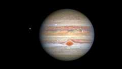 Image of Jupiter shows bands of orange and yellow sweeping across the surface with a distinctive big red spot in the clouds.