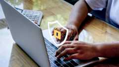 Hands typing on a laptop computer with a lock icon