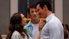 Elizabeth Olsen staring up at Callum Turner while Miles Teller watches in Eternity