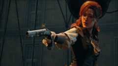 Elise points a pistol while standing in a hot-air balloon