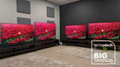 Deal image with four OLED TVs displaying red flowers on their screens with big savings logo in white