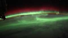 green aurora waves over earth