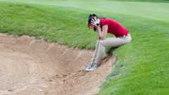 Female golfer in despair in bunker