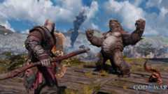 Games like God of War Ragnarok: Kratos fighting a giant monster on a mountain top.