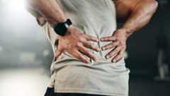 a man holding his back in pain