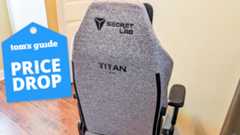 A Secretlab Titan Evo chair in a hallway with a Tom's Guide Price Drop deals badge on top